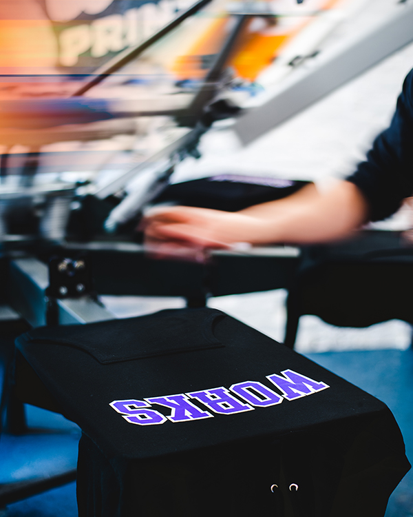 Screen printing a hoodie on an automatic screen printing press