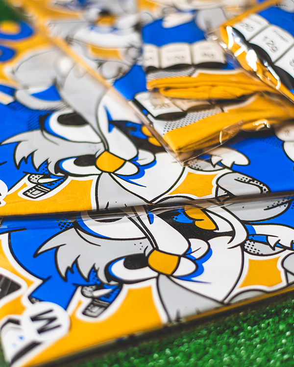 Folded and bagged tour merchandise prepared in the UK ready for sale at shows